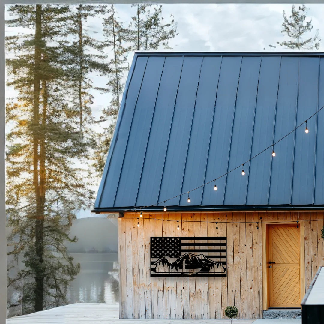 A laser-cut American flag wall piece with mountain silhouettes brings patriotic rustic charm to the exterior of this lakeside cabin.