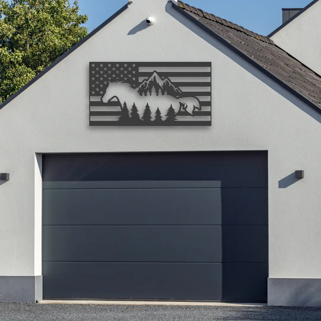 A layered metal american flag wall decor combines horses, trees, and peaks for bold contrast on a garage wall, perfect for fans of rural and horse farm signs styling.