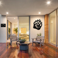 A cozy patio scene featuring a rugged black house number metal sign with mountain elements and a bold bear paw design — a standout piece of metal yard art that captures the wild spirit of outdoor living.