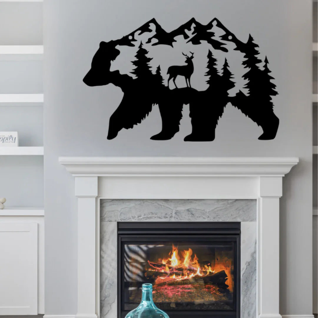 A bold black metal wall art of a bear with forest and deer silhouette detail mounted above a fireplace, creating a striking focal point in a modern rustic living room.