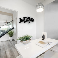This modern workspace gains personality through a dramatic wall art fishing scene, featuring trees and water inside a fish silhouette.