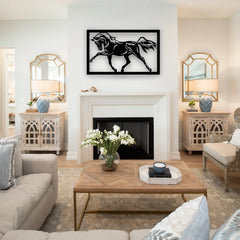 A black metal horse signs piece framed in black gallops above a white fireplace, bringing energy and movement to a light and airy traditional living room.