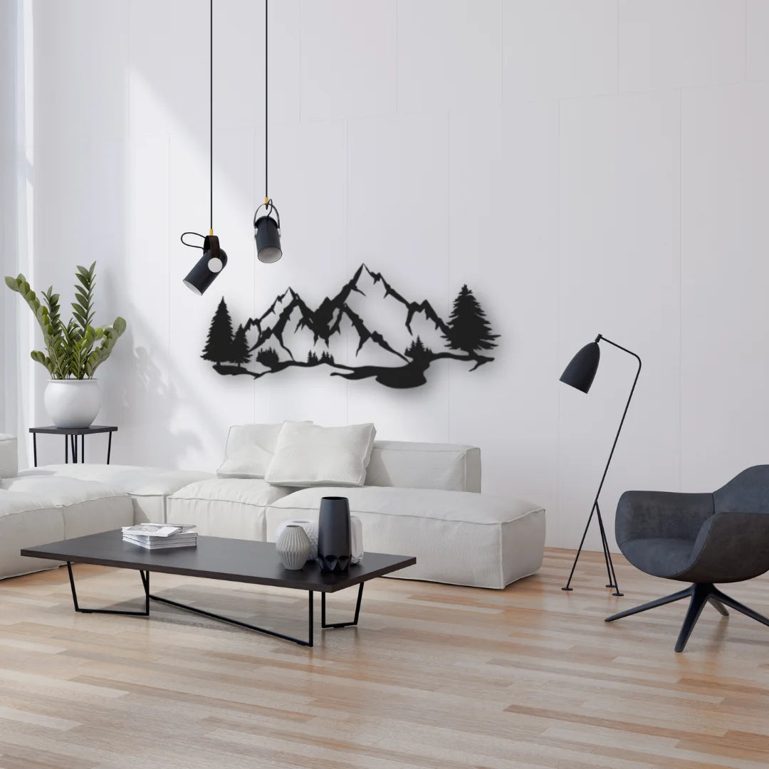 A dramatic black silhouette of mountains art brings bold contrast and a grounded, nature-inspired energy to this airy modern living room.