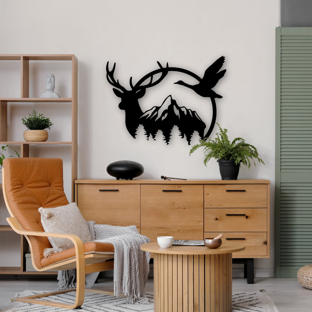 This black metal artwork features a deer, flying goose, and pine trees with mountains in the backdrop—bringing the outdoors inside with a silhouette-style metal design.