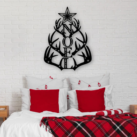 A holiday metal deer sign shaped like antlers spelling “NOEL” sits above a red-accented bed, making this piece a bold and rustic metal christmas signs option for the bedroom.