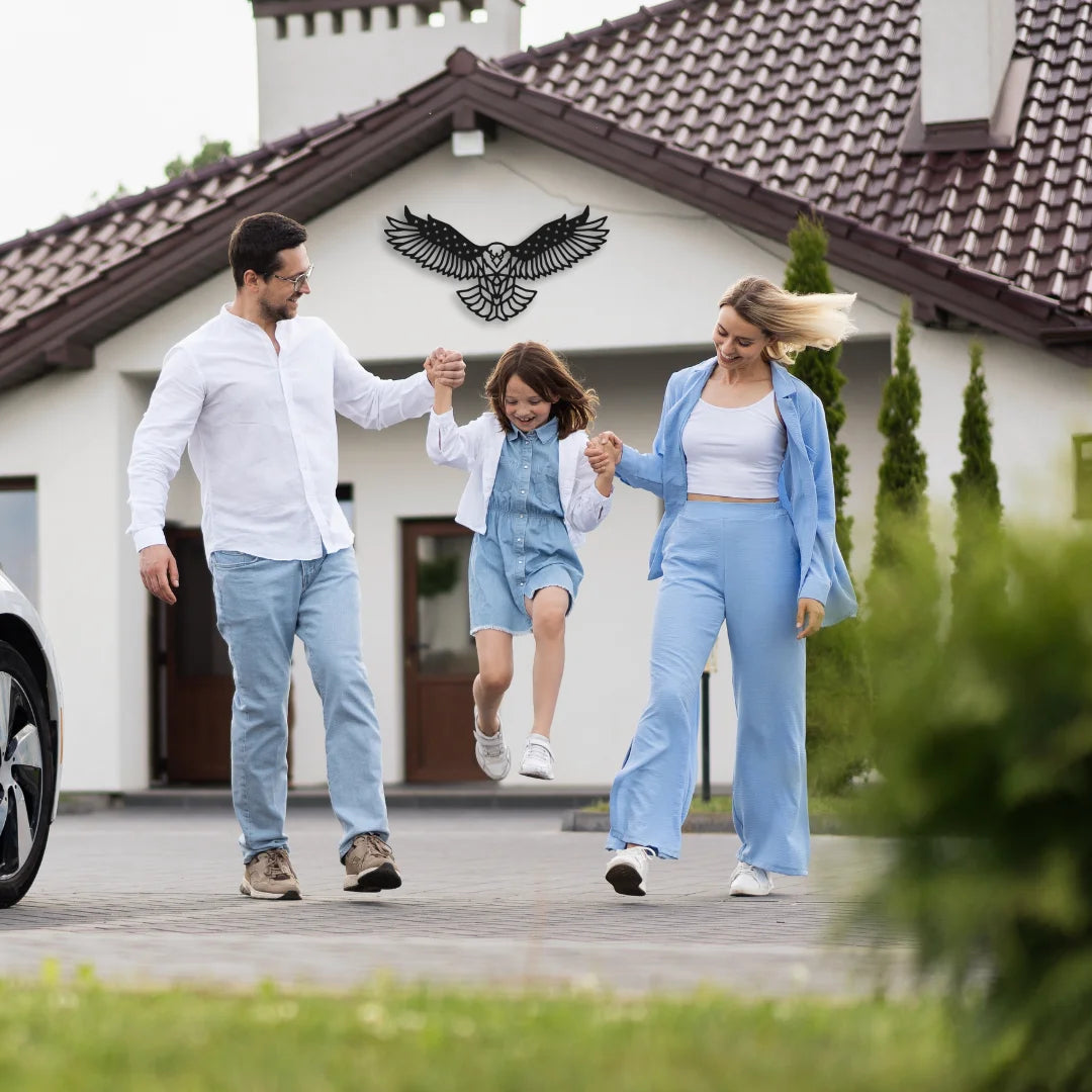 A soaring patriot signage of an eagle mounted above the house entrance reflects strength and pride behind a joyful family moment.