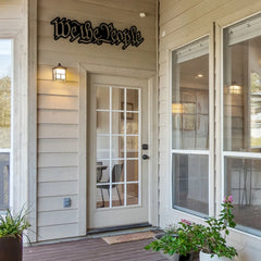 A patriotic metal outdoor sign with the phrase “We the People” mounted above the porch entrance, ideal for American-style exteriors.