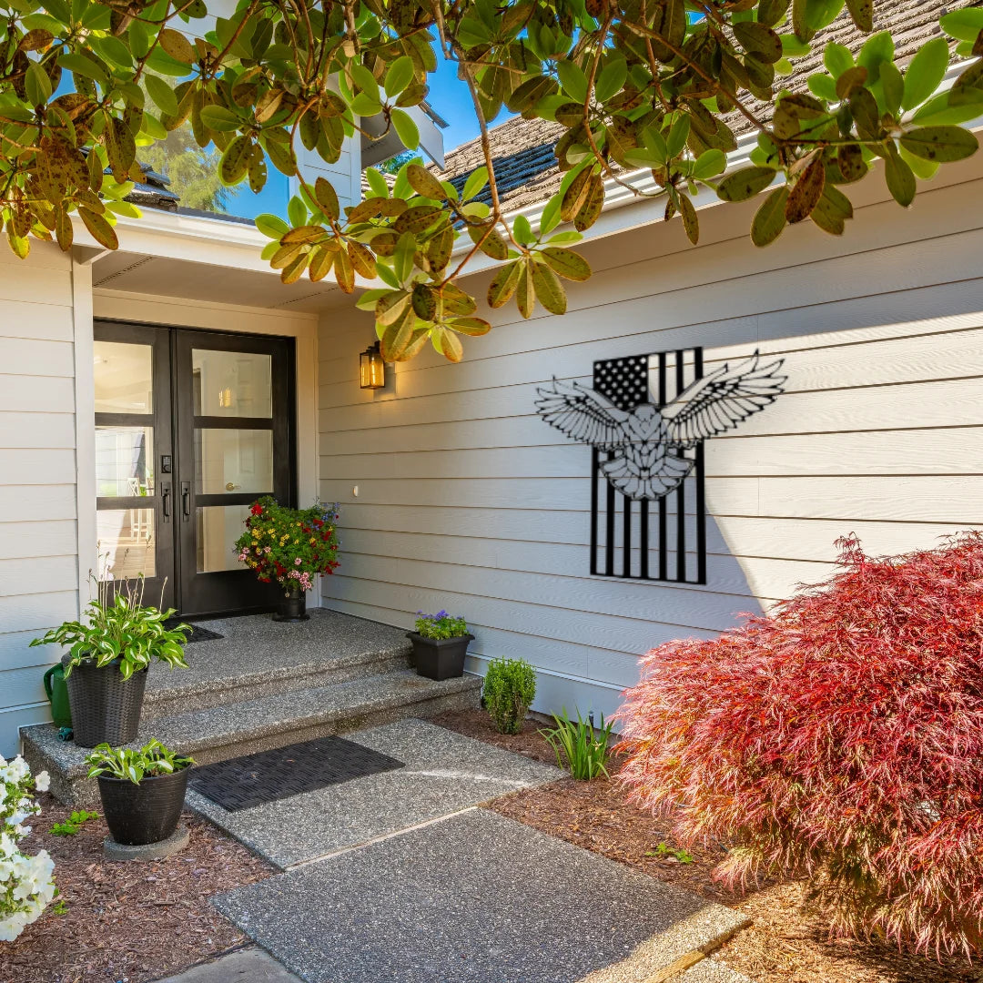 A bold bald eagle decor with American flag detail makes a patriotic statement outside a modern front porch.
