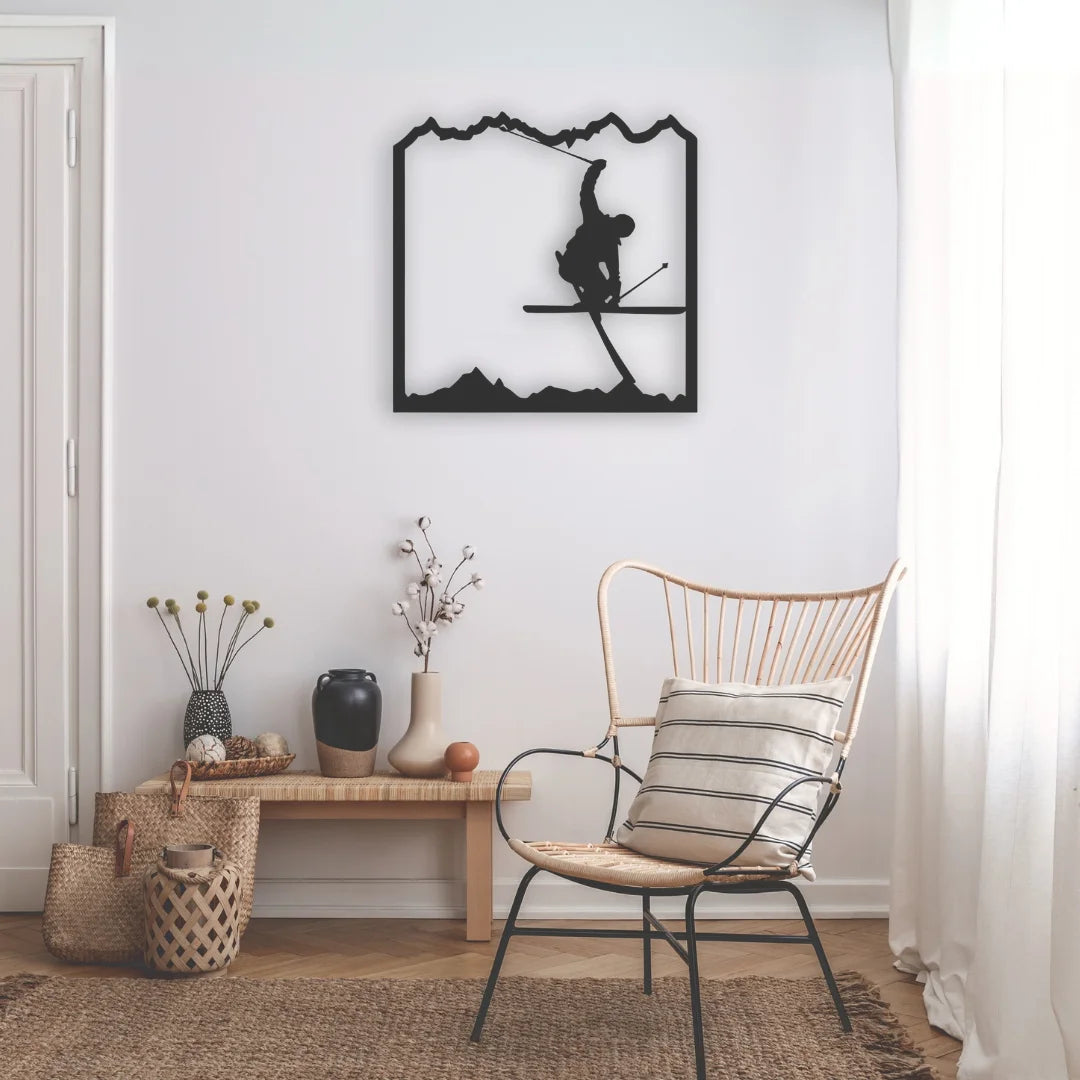 A minimalist metal wall decor black of a skier catching air in the mountains, perfect for alpine enthusiasts seeking bold, dynamic wall art.
