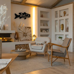 A warm-toned living room showcases a detailed fish wall art decor piece above the fireplace, blending rustic style with cozy elegance.