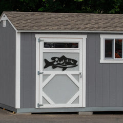 A bold black steel fish wall art decor shaped like a fish with trees and moonlight appears on a shed door, perfect for anglers or rustic backyard vibes.
