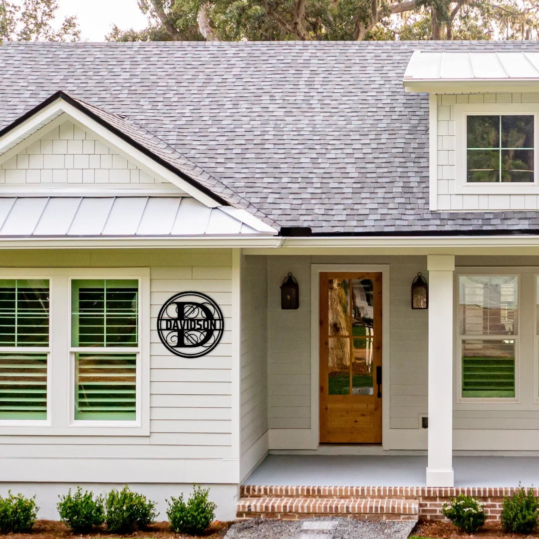 A custom round last name monogram displayed proudly near the entrance, offering a stylish way to personalize a home’s exterior.
