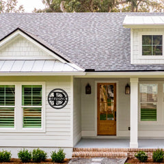 A custom round last name monogram displayed proudly near the entrance, offering a stylish way to personalize a home’s exterior.
