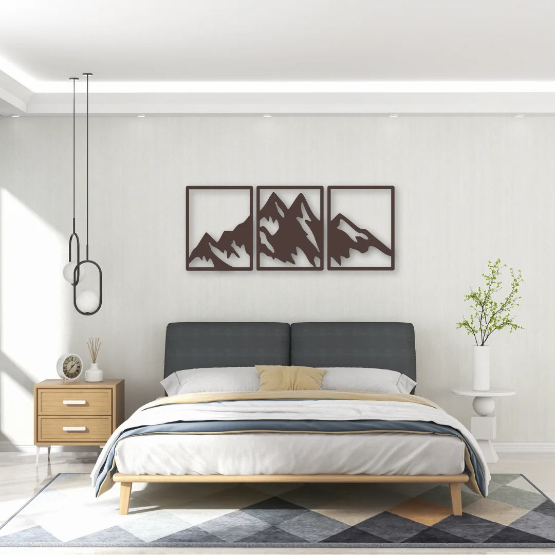 Framed silhouettes of a mountain range in a triptych design deliver elegant above headboard decor with serene balance.
