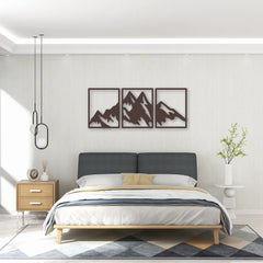 Framed silhouettes of a mountain range in a triptych design deliver elegant above headboard decor with serene balance.
