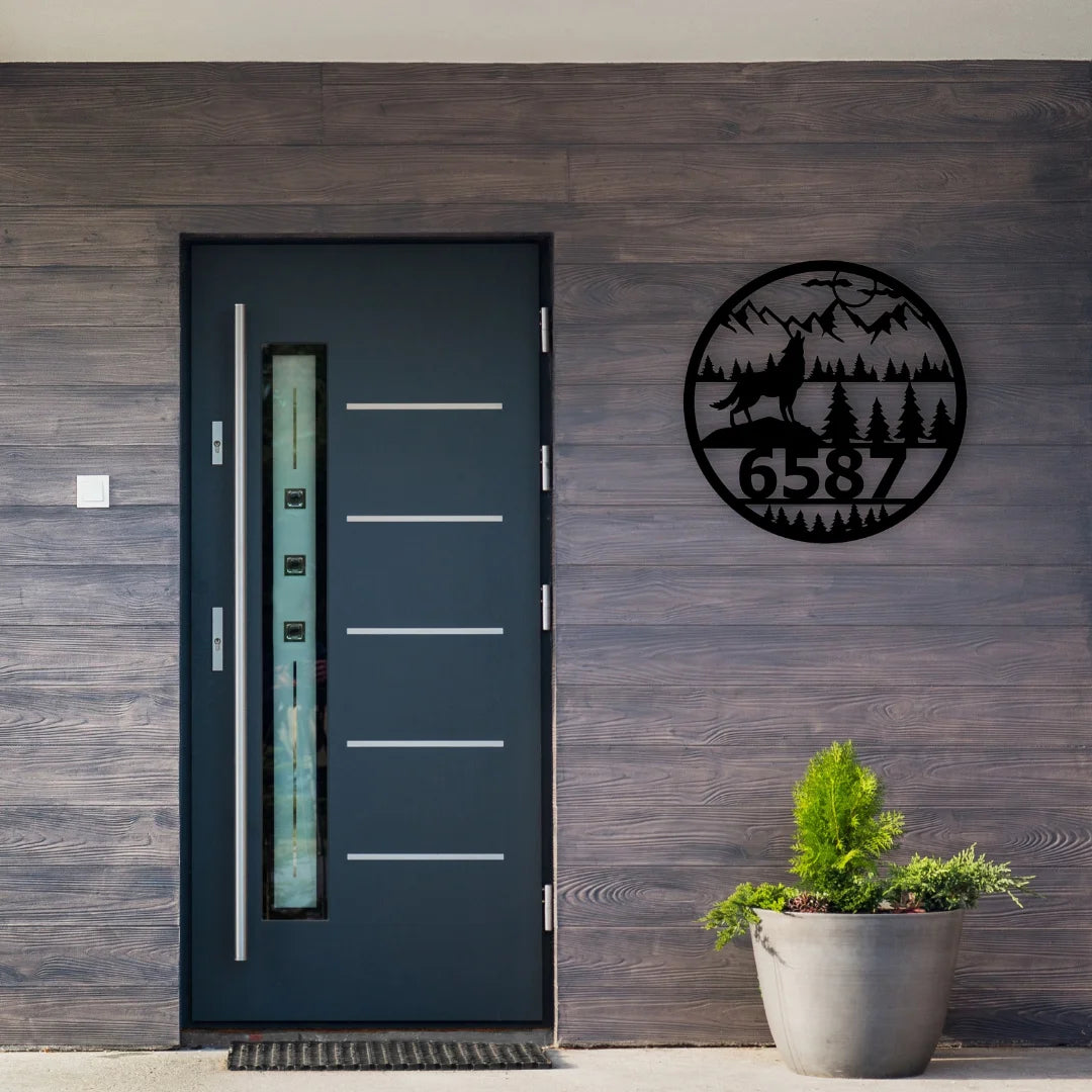 A custom round address sign metal featuring forest, mountains, and howling wolf, paired with bold house numbers to enhance your entryway.
