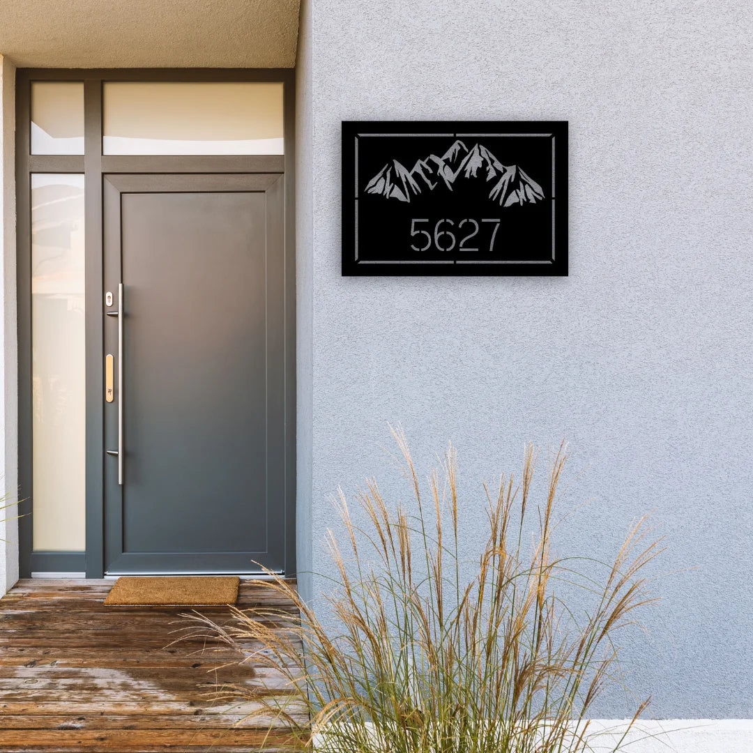A rectangular house number signs yard design with detailed mountain peaks and bold numbers, enhancing curb appeal with rugged character.
