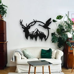 A black circular custom deer and mountain wall art decor adds a sense of wilderness above a white sofa in a modern living room filled with natural accents.
