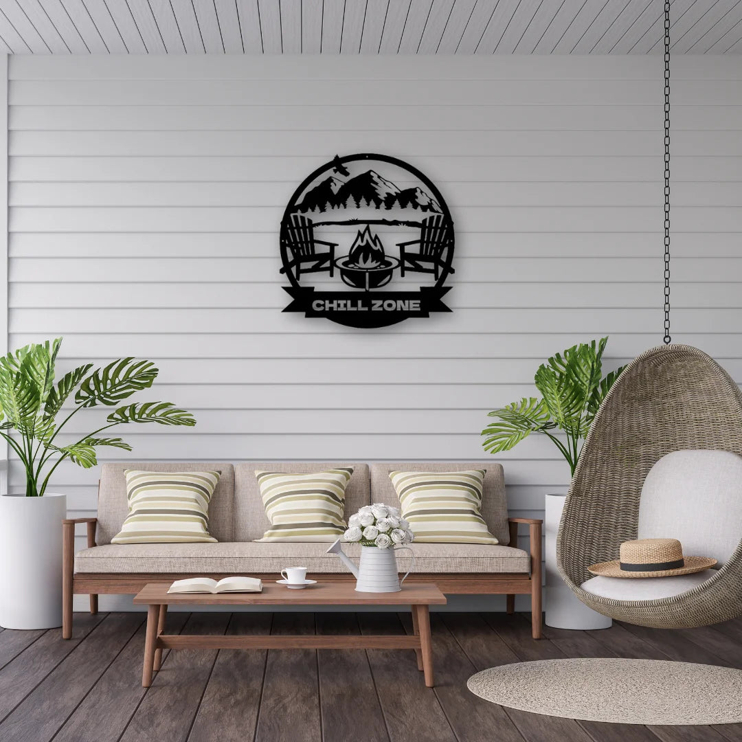 A round custom man cave sign reading “Chill Zone” with mountains and camp chairs, setting a cozy vibe in this breezy outdoor lounge.

