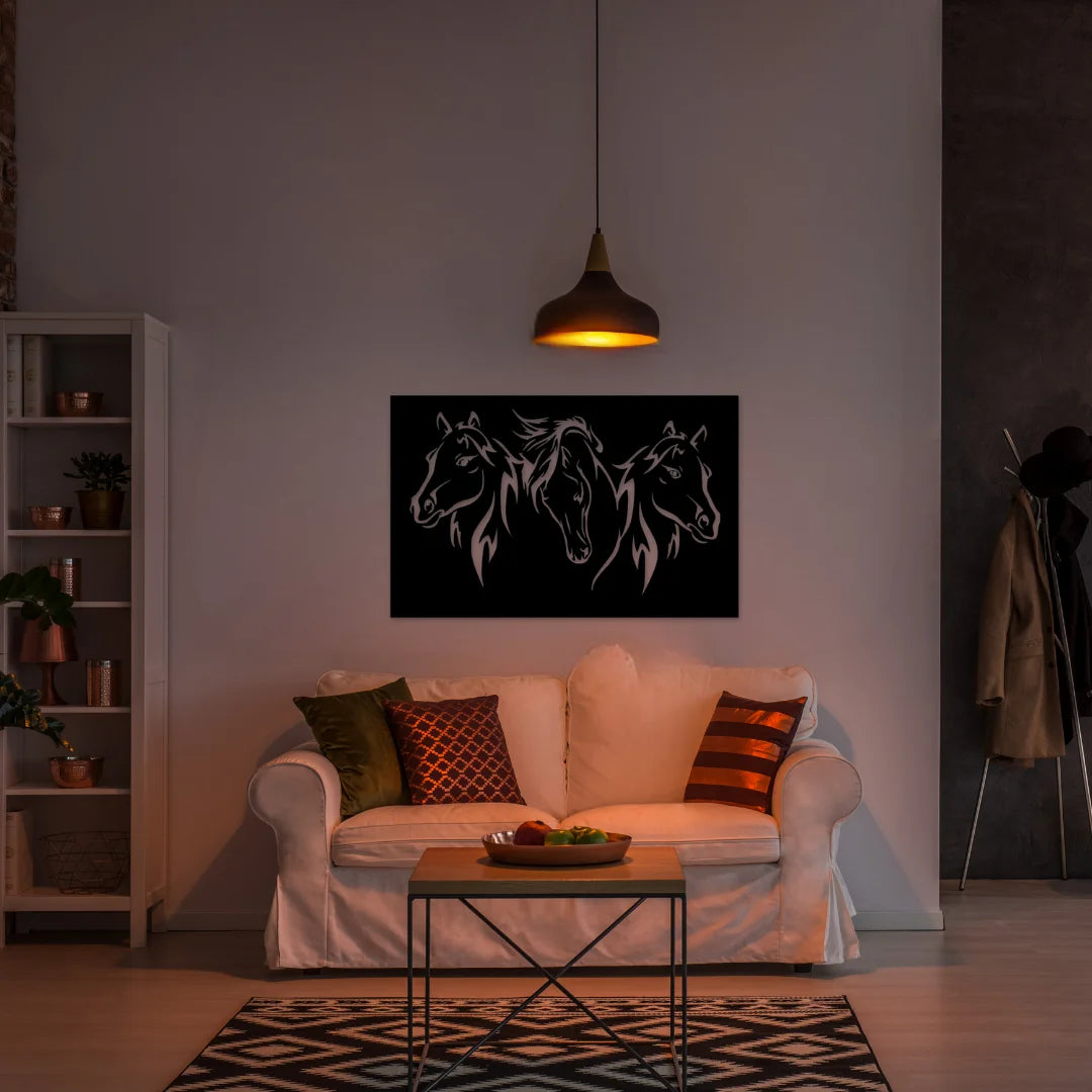 A dramatic black panel of metal horse signs with three horse heads enhances a moody, softly lit living room styled in earthy tones and cozy textures.
