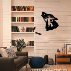 A cozy reading nook with a black metal wall ornament featuring a howling wolf and mountain scene, mounted on a pale wood wall above neutral rustic decor.

